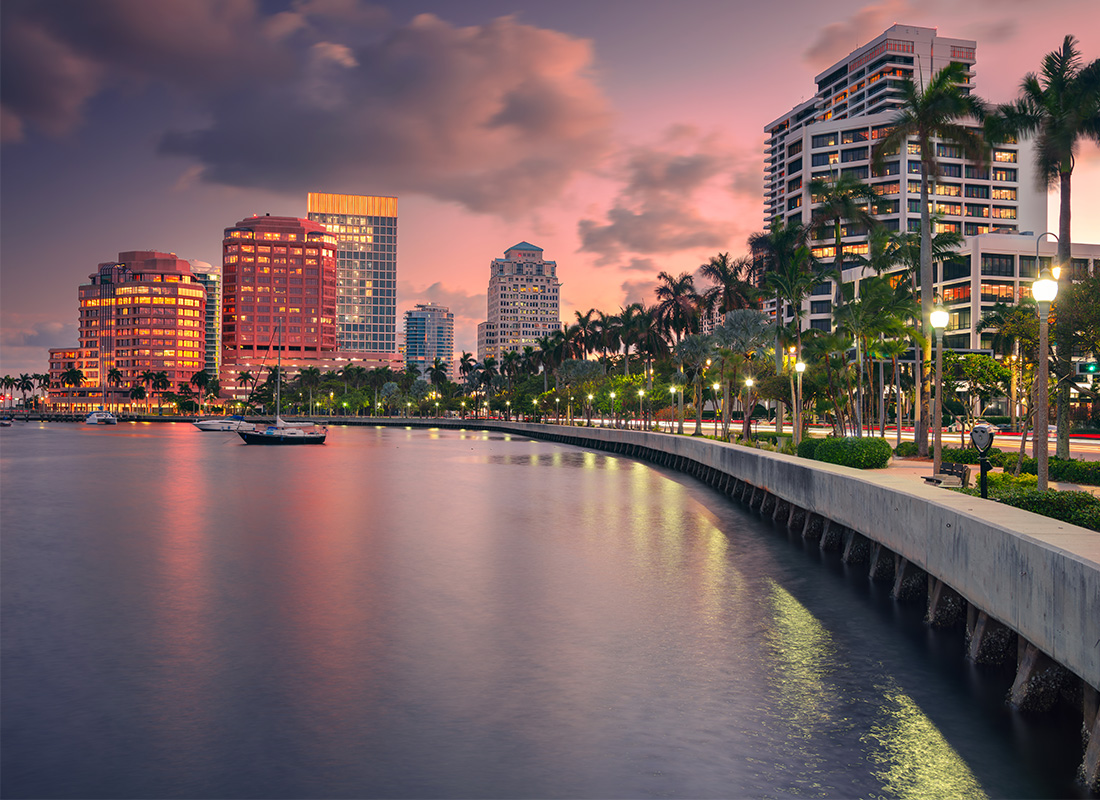 Palm Beach Gardens, Florida Insurance - Skyline of West Palm Beach, Florida at Dusk with Reflections on Water